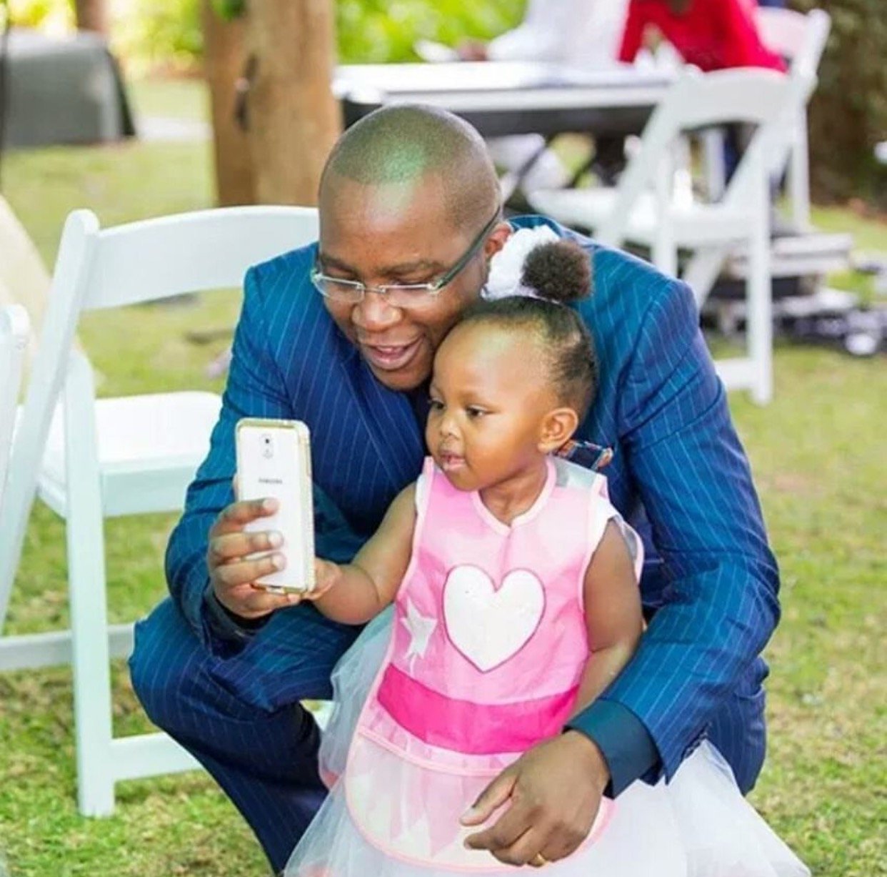Jimmy Gathu with his grand-daughter 