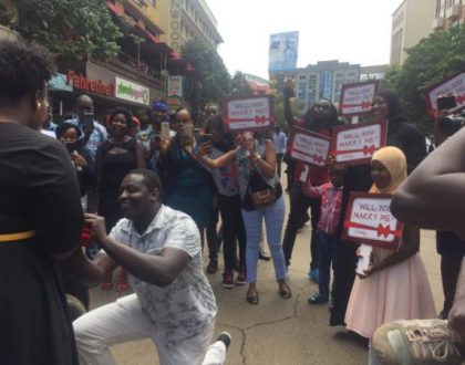 Little known comedian raises the bar for single men as he blocks traffic on Kimathi Street just to propose to his sweetheart (Photos)