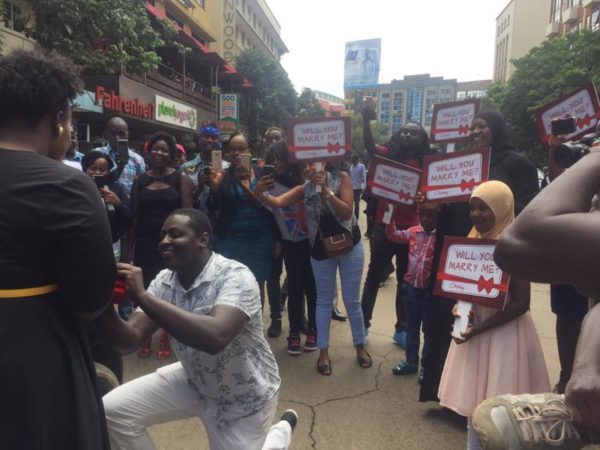 Little known comedian raises the bar for single men as he blocks traffic on Kimathi Street just to propose to his sweetheart (Photos)