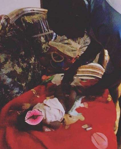 Benson Gatu changing his baby's diapers