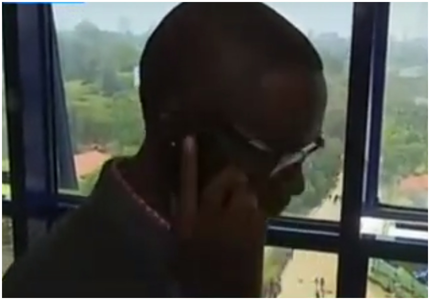 Eza Chiloba peeps through the window as police teargas Nasa supporters demonstrating against him (Video)