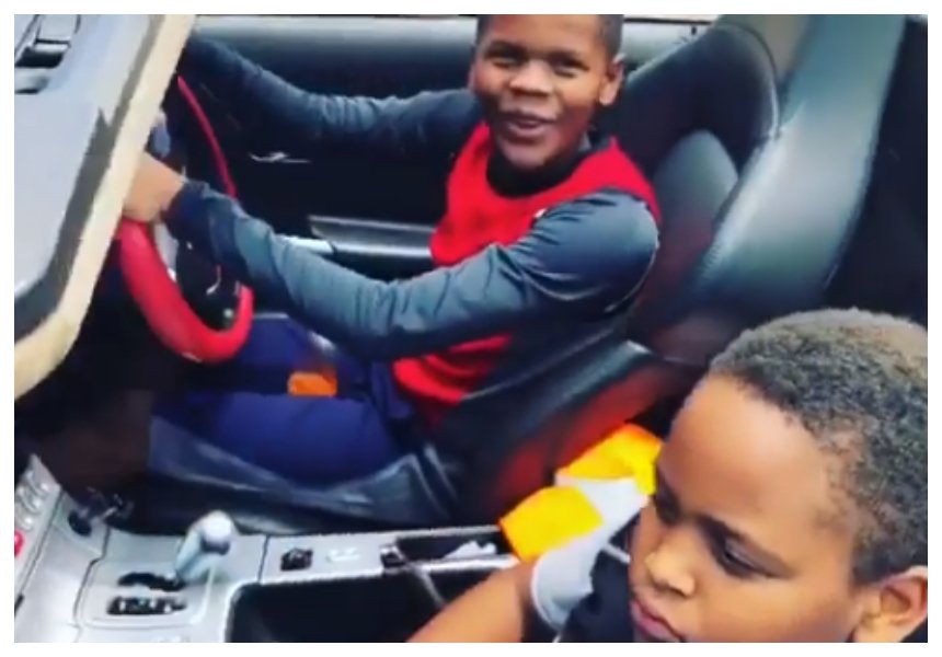 Jose Chameleone impressed by his underage sons driving his Chrysler on a highway (Video)