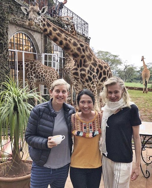 Ellen DeGeneres, her wife Portia de Rossi and a friend pose for a photo at the Giraffe Manor