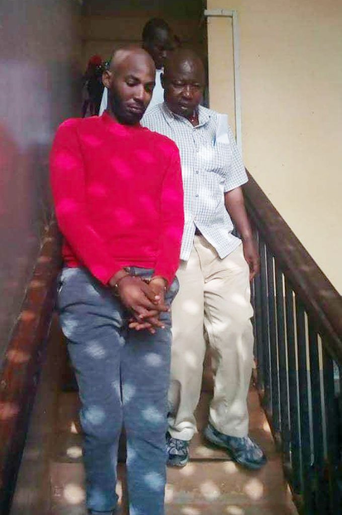 Key suspect in Mowzey Radio's death Godfrey Wamala aka Troy (handcuffed) 