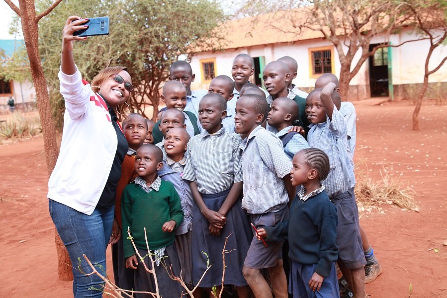 Airtel’s Marion Wambua takes a selfie with the pupils at St. Michael Matulani Primary School.