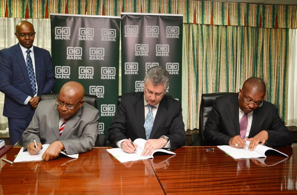 (L-R) The Chairman, Co-operative Bank John Murugu, Fleet Global Chief Operating Officer Super Group, Philip Smith and Group Managing Director and CEO Co-operative Bank Dr. Gideon Muriuki sign-off the joint venture strategic partnership arrangement in leasing business, witnessed by Company Secretary Co-operative Bank Samuel Kibugi (standing).
