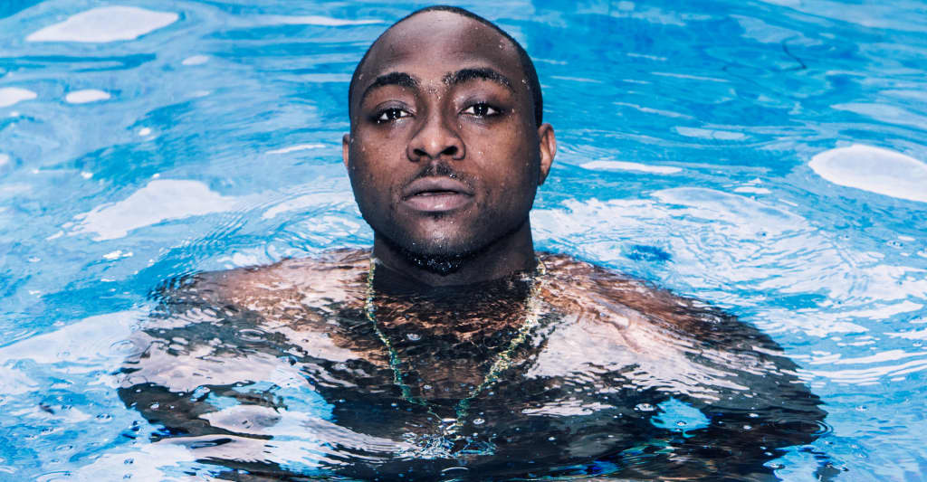 Davido Accused of Dashing his Used Clothes to his Crew Members