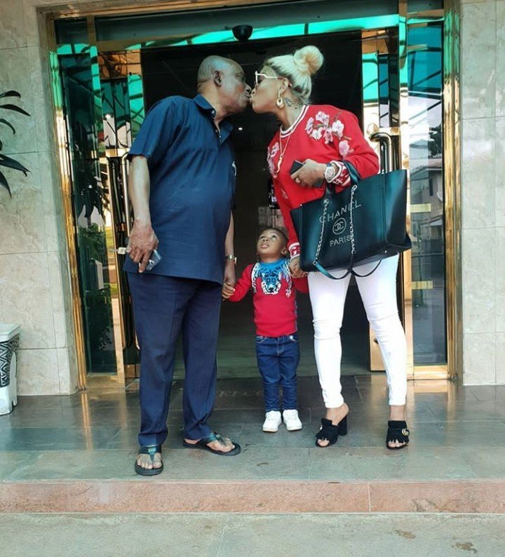 Tonto Dikeh pictured kissing her father as her son King Andre looks on