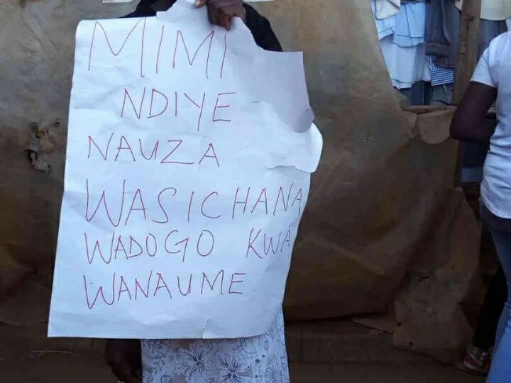 Woman frog-matched across the streets of Thika carrying a placard after she was busted hooking up young girls with old HIV+ man (Photos)